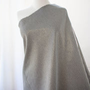 gorgeous silk ottoman suiting fabric by the yard. Featuring classic black and white horizontal stripe, enhanced by the subtle shimmer of gold metallic threads. Perfect for creating a formal gown, suiting, or a lovely lightweight coat to pair with that little black dress! Image of fabric on dressform.