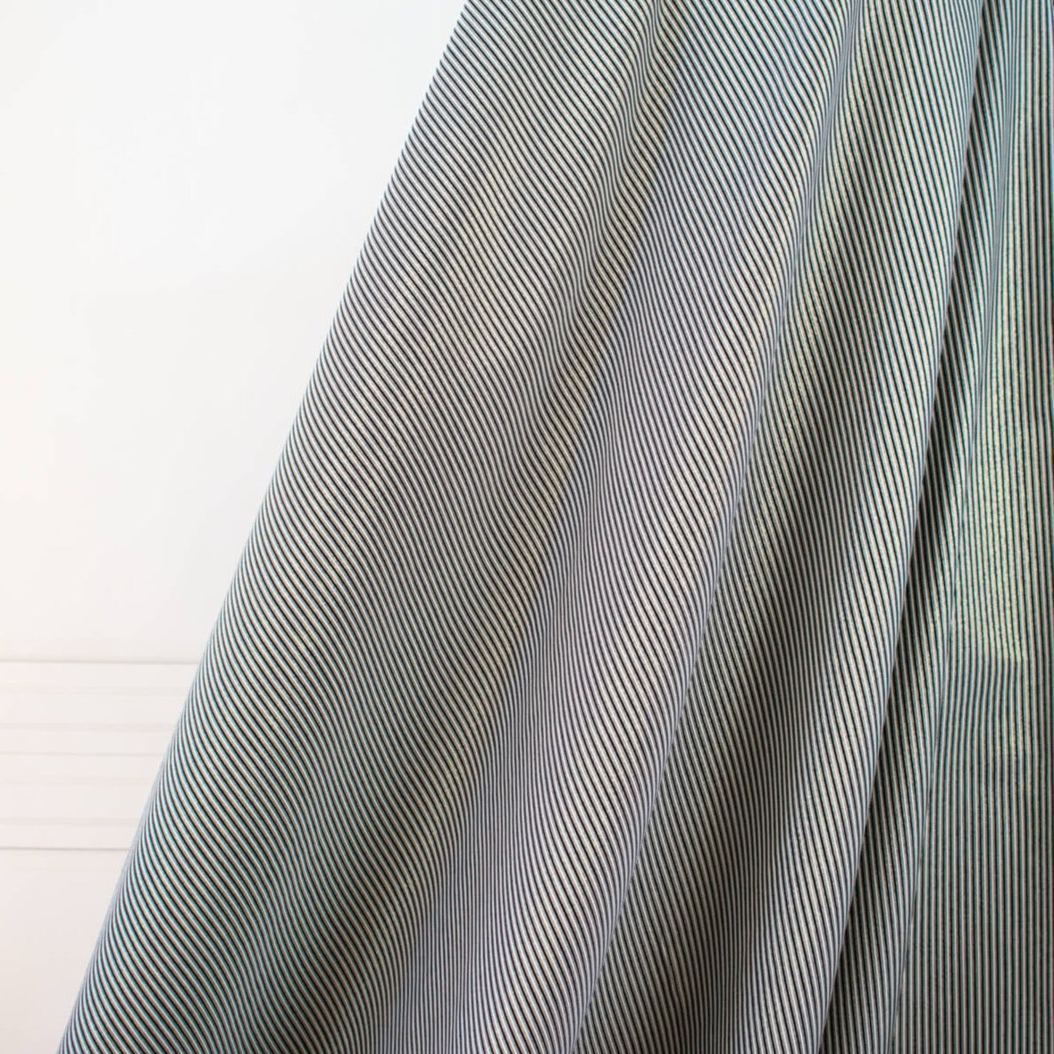 gorgeous silk ottoman suiting fabric by the yard. Featuring classic black and white horizontal stripe, enhanced by the subtle shimmer of gold metallic threads. Perfect for creating a formal gown, suiting, or a lovely lightweight coat to pair with that little black dress! Image of fabric drape.