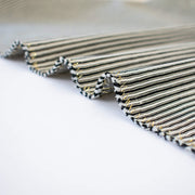 gorgeous silk ottoman suiting fabric by the yard. Featuring classic black and white horizontal stripe, enhanced by the subtle shimmer of gold metallic threads. Perfect for creating a formal gown, suiting, or a lovely lightweight coat to pair with that little black dress! Close up image of selvedge.