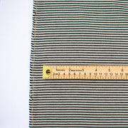 gorgeous silk ottoman suiting fabric by the yard. Featuring classic black and white horizontal stripe, enhanced by the subtle shimmer of gold metallic threads. Perfect for creating a formal gown, suiting, or a lovely lightweight coat to pair with that little black dress! Image of fabric with ruler for design scale.