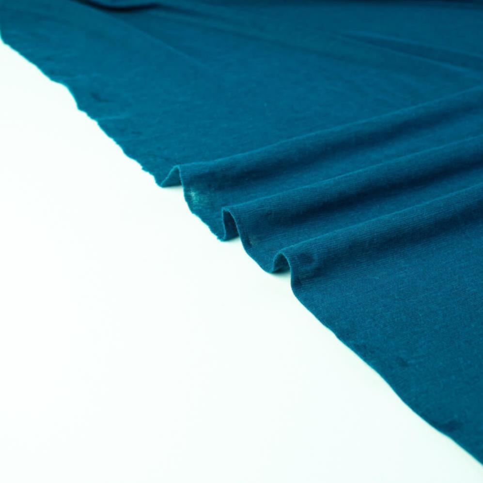 Italian Viscose Tissue Jersey designer deadstock fabric by the yard. Enjoy a bit of high-end designer British luxury! Casual, elegant, and soft, this tissue jersey has a lovely drape, thin hand, and is light and translucent. Perfect for a dress, loungewear, or T-Shirt or layering piece. Image of selvedge,