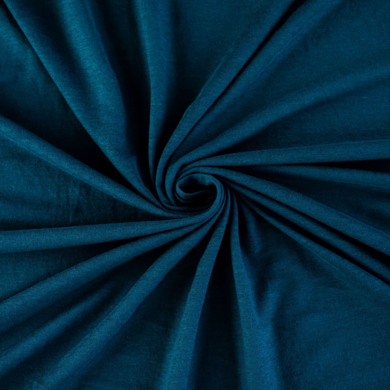 Italian Viscose Tissue Jersey designer deadstock fabric by the yard. Enjoy a bit of high-end designer British luxury! Casual, elegant, and soft, this tissue jersey has a lovely drape, thin hand, and is light and translucent. Perfect for a dress, loungewear, or T-Shirt or layering piece. Image of fabric fullness.
