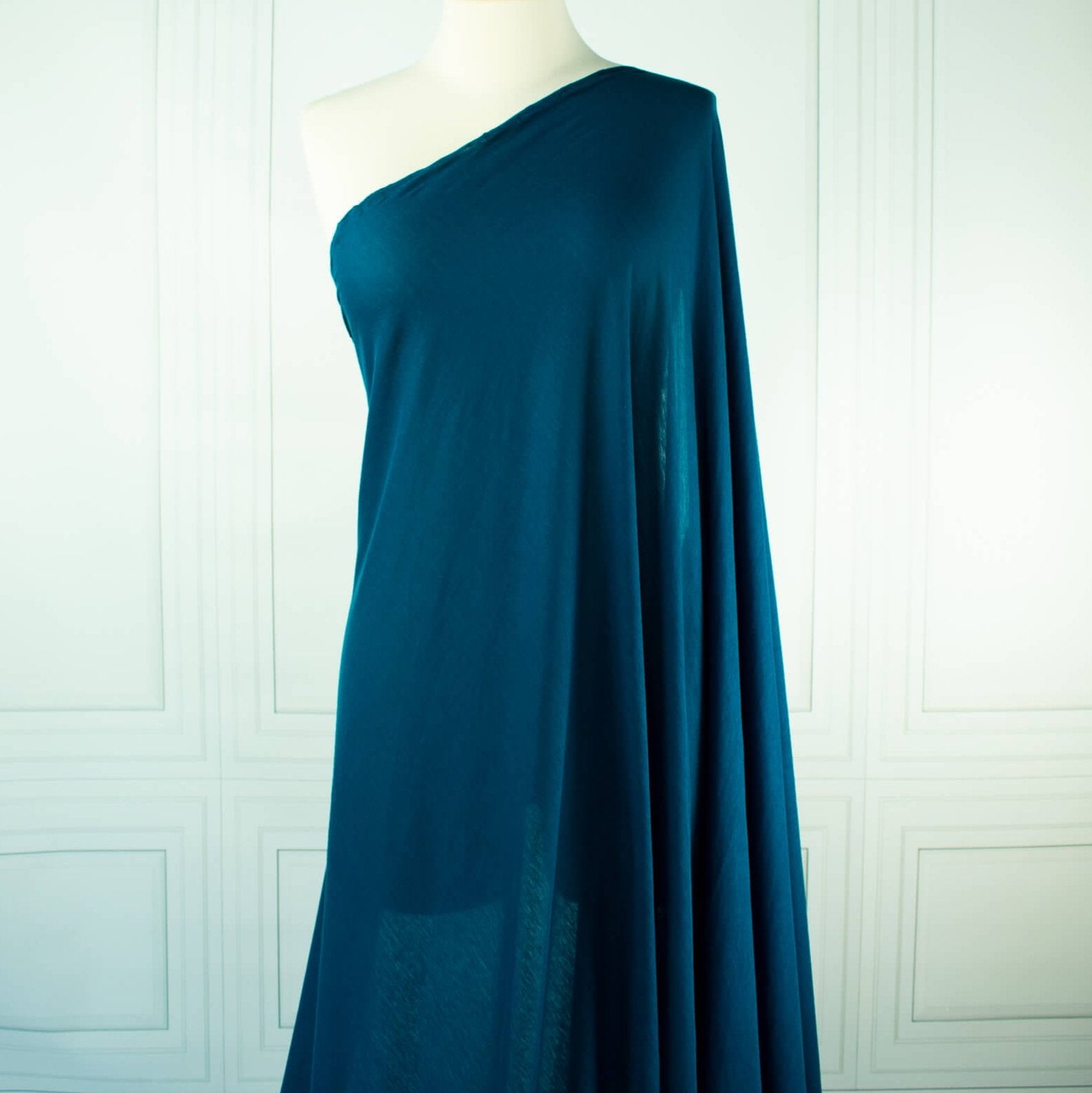 Italian Viscose Tissue Jersey designer deadstock fabric by the yard. Enjoy a bit of high-end designer British luxury! Casual, elegant, and soft, this tissue jersey has a lovely drape, thin hand, and is light and translucent. Perfect for a dress, loungewear, or T-Shirt or layering piece. Image of fabric on dressform.
