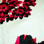 Italian Floral Silk satin designer deadstock fabric by the yard. Ready to create something gorgeous with our silk satin fabric of red and pink blooms highlighted by a bit of black for drama set against a white background. This thin woven silk from the Italian mills has a smooth satiny hand and just the right amount of flow! Image of fabric printing defect.