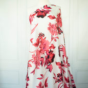 Italian Floral Silk satin designer deadstock fabric by the yard. Ready to create something gorgeous with our silk satin fabric of red and pink blooms highlighted by a bit of black for drama set against a white background. This thin woven silk from the Italian mills has a smooth satiny hand and just the right amount of flow! Image of fabric draped on dressform.