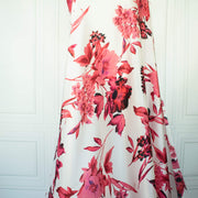 Italian Floral Silk satin designer deadstock fabric by the yard. Ready to create something gorgeous with our silk satin fabric of red and pink blooms highlighted by a bit of black for drama set against a white background. This thin woven silk from the Italian mills has a smooth satiny hand and just the right amount of flow! Image of fabric drape.