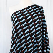 Italian Geometric Poly Satin designer deadstock fabric by the yard. From the Italian mills, a gorgeous satin with a modern palette of light blue, earthy brown and black that will elevate your next sewing project! Image of fabric draped on dressform.