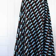 Italian Geometric Poly Satin designer deadstock fabric by the yard. From the Italian mills, a gorgeous satin with a modern palette of light blue, earthy brown and black that will elevate your next sewing project! Image of fabric drape.