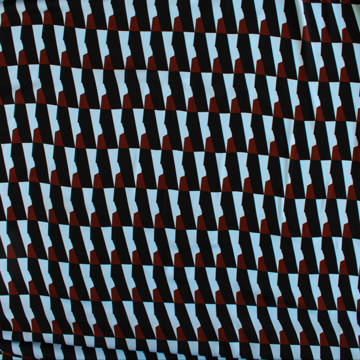 Italian Geometric Poly Satin designer deadstock fabric by the yard. From the Italian mills, a gorgeous satin with a modern palette of light blue, earthy brown and black that will elevate your next sewing project! Image of fabric design.