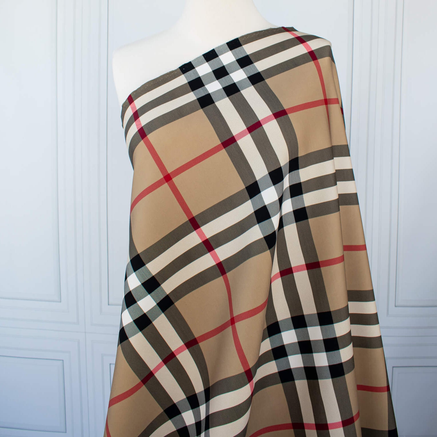 Couture British Designer Plaid Scuba Knit designer deadstock fabric by the yard. Bring on that London Style, in a classic plaid with a bit of a twist...it's scuba! Image of fabric draped on dressform.