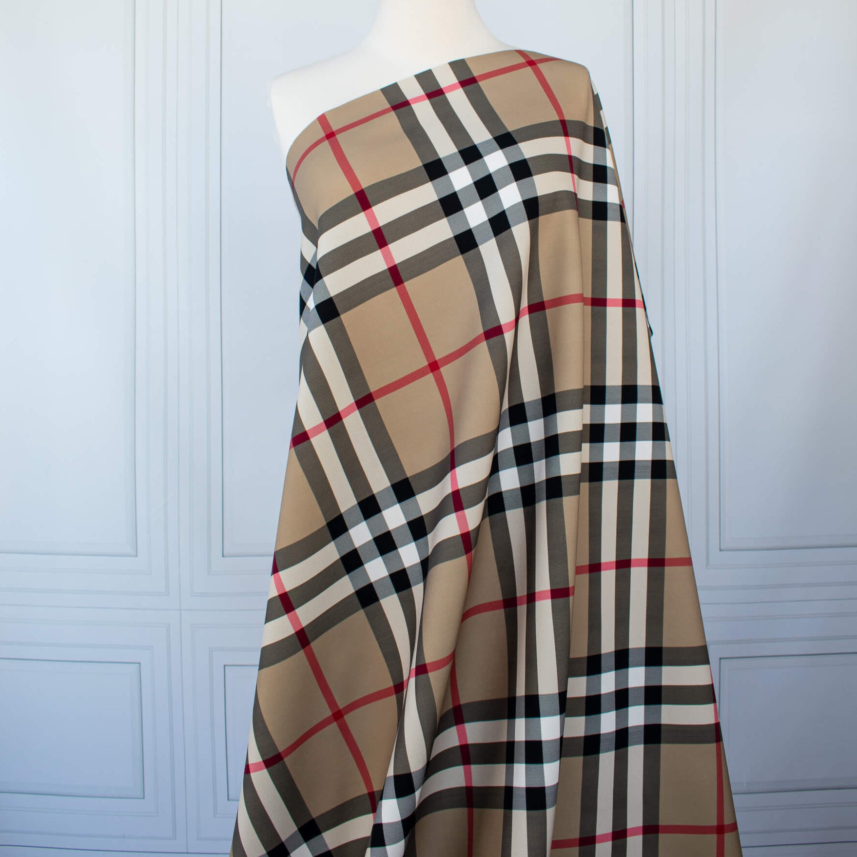 Couture British Designer Plaid Scuba Knit designer deadstock fabric by the yard. Bring on that London Style, in a classic plaid with a bit of a twist...it's scuba! Image of fabric draped on dressform.