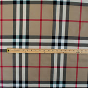 Couture British Designer Plaid Scuba Knit designer deadstock fabric by the yard. Bring on that London Style, in a classic plaid with a bit of a twist...it's scuba! Image of fabric design with ruler.