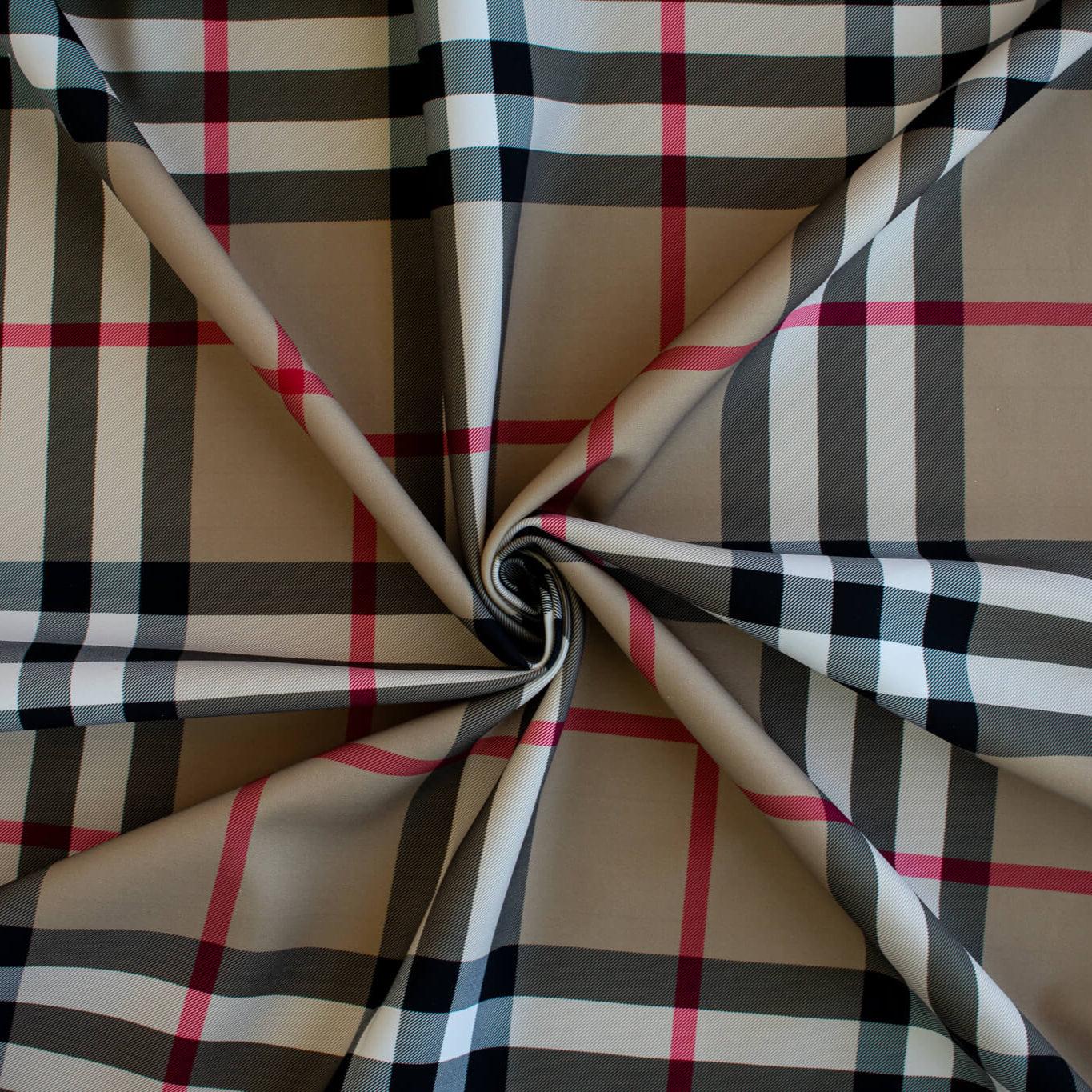 Couture British Designer Plaid Scuba Knit designer deadstock fabric by the yard. Bring on that London Style, in a classic plaid with a bit of a twist...it's scuba! Image of fabric fullness.