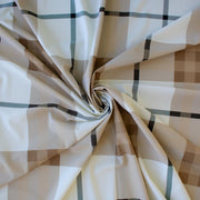 Couture British Designer Plaid Knit designer deadstock fabric by the yard. Bring on that London Style, in a knit! If you are looking to sew up some resort pieces this season then this is your knit. The cool sleek hand and drape of this fabric is perfect for swimwear, coverups, tops and cute dresses and skirts. Image of fabric fullness.