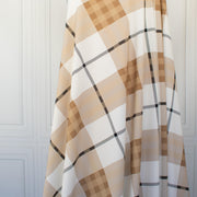 Couture British Designer Plaid Knit designer deadstock fabric by the yard. Bring on that London Style, in a knit! If you are looking to sew up some resort pieces this season then this is your knit. The cool sleek hand and drape of this fabric is perfect for swimwear, coverups, tops and cute dresses and skirts. Image of fabric drape.
