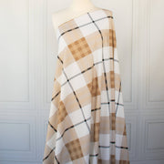 Couture British Designer Plaid Knit designer deadstock fabric by the yard. Bring on that London Style, in a knit! If you are looking to sew up some resort pieces this season then this is your knit. The cool sleek hand and drape of this fabric is perfect for swimwear, coverups, tops and cute dresses and skirts. Image of fabric draped on dressform.