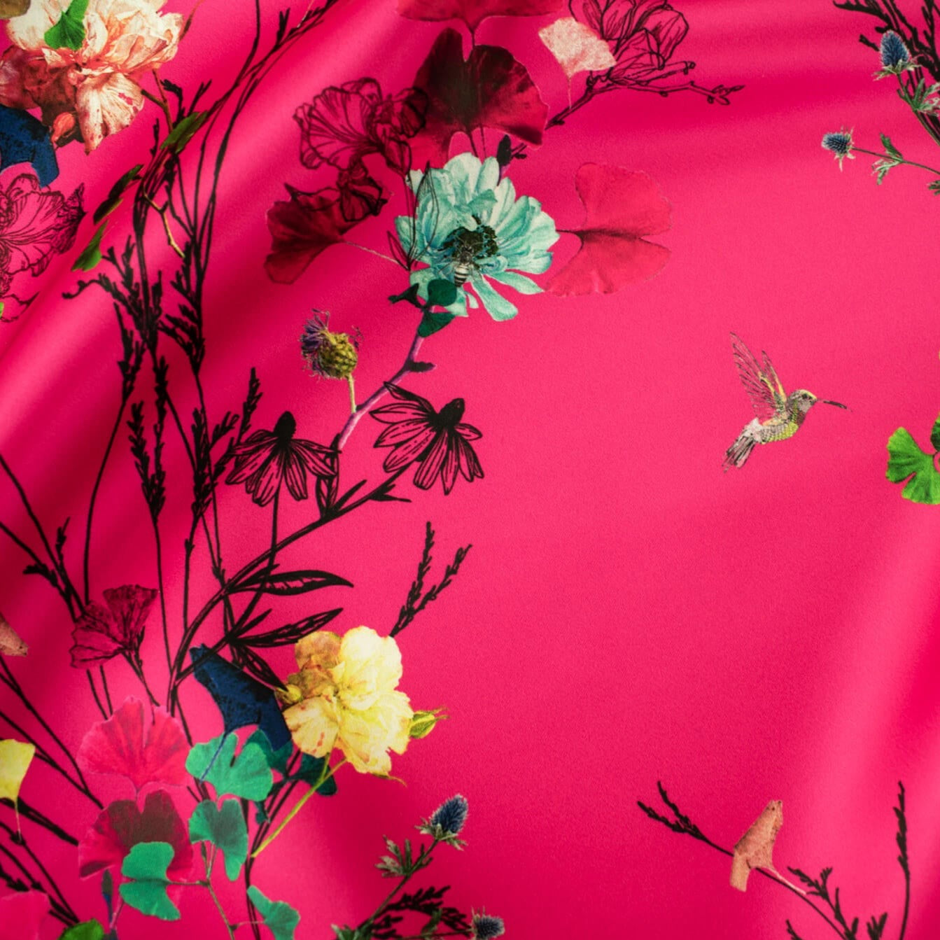Couture dark pink duchesse satin fabric by the yard is perfect for standing out at weddings or any fancy event. With a gorgeous trailing floral vine, this dead stock fabric captures pure elegance.  Originating from the Italian mills, and sourced from a designer who has dressed celebrities on the red carpet this densely woven matte satin has a smooth hand and fuller body, with a sponginess that would create a lovely column gown, corset top, or full skirt. Close up image