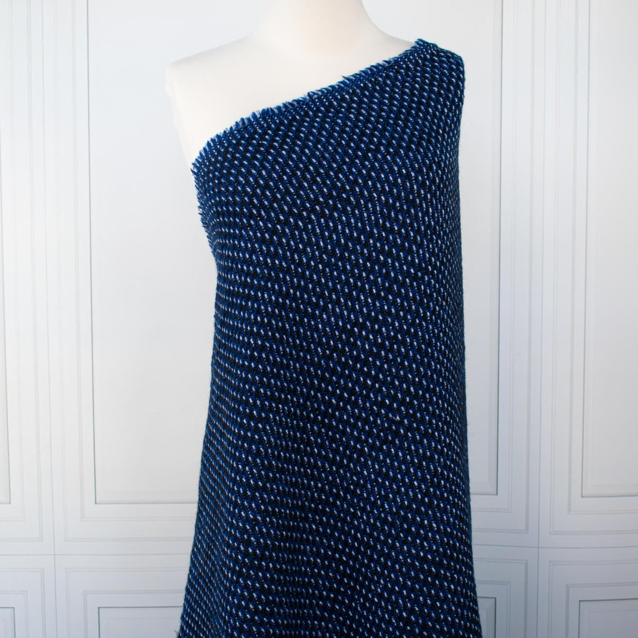 This is a lovely wool boucle fabric by the yard imported from Italy.  Dress it up or down, you will love the softness. It has a nice hand and soft drape, ideal for your ClassicFrench Jacket with a fantastic selvedge! Image of fabric draped on dressform.