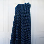 This is a lovely wool boucle fabric by the yard imported from Italy. Dress it up or down, you will love the softness. It has a nice hand and soft drape, ideal for your ClassicFrench Jacket with a fantastic selvedge! Image of fabric drape.