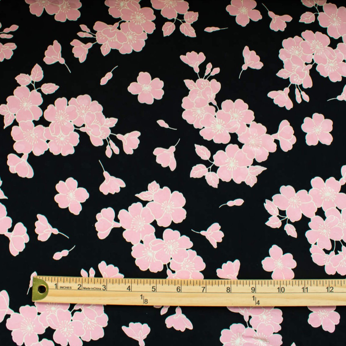 Couture Italian Viscose Floral Jacquard - 'All My Heart'! This stunning designer deadstock fabric by the yard features a gorgeous black base with delicate pink florals and ivory accents. Plus, playful and trending jacquard hearts add a touch of whimsy. 
Featuring a nice drape that falls away from the body and slightly textured hand, you'll find this fabric is perfect for formal attire or a little something special.  Image of pattern design scale with ruler.