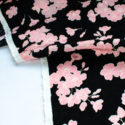 Couture Italian Viscose Floral Jacquard - 'All My Heart'! This stunning designer deadstock fabric by the yard features a gorgeous black base with delicate pink florals and ivory accents. Plus, playful and trending jacquard hearts add a touch of whimsy. 
Featuring a nice drape that falls away from the body and slightly textured hand, you'll find this fabric is perfect for formal attire or a little something special.  Image of selvedge.