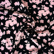 Couture Italian Viscose Floral Jacquard - 'All My Heart'! This stunning designer deadstock fabric by the yard features a gorgeous black base with delicate pink florals and ivory accents. Plus, playful and trending jacquard hearts add a touch of whimsy. 
Featuring a nice drape that falls away from the body and slightly textured hand, you'll find this fabric is perfect for formal attire or a little something special.  Image of fabric fullness.
