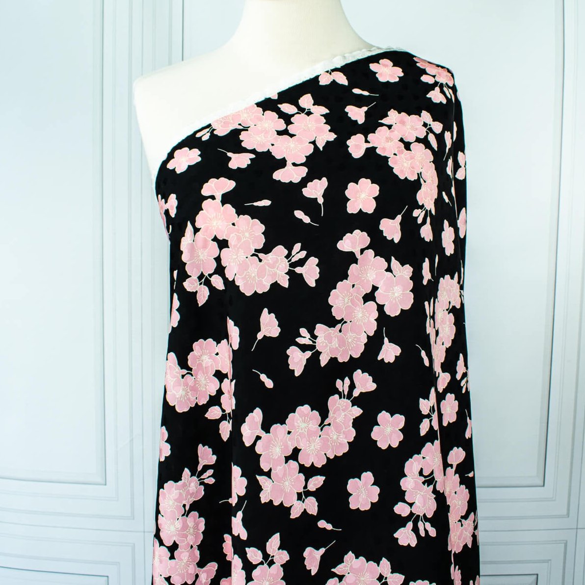 Couture Italian Viscose Floral Jacquard - 'All My Heart'! This stunning designer deadstock fabric by the yard features a gorgeous black base with delicate pink florals and ivory accents. Plus, playful and trending jacquard hearts add a touch of whimsy. 
Featuring a nice drape that falls away from the body and slightly textured hand, you'll find this fabric is perfect for formal attire or a little something special.  Image of fabric draped on dressform.