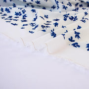 Image of selvedge. Couture, Italian, blue and white floral crepe deadstock fabric by the yard. Sourced from a Los Angeles designer of ready-to-wear and bridal pieces and a favorite among some of Hollywoods A-List stars!