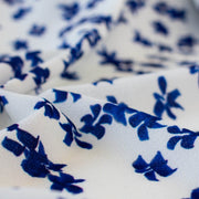 Close up image. Couture, Italian, blue and white floral crepe deadstock fabric by the yard. Sourced from a Los Angeles designer of ready-to-wear and bridal pieces and a favorite among some of Hollywoods A-List stars!