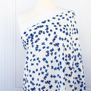 Image of fabric on dressform. Couture, Italian, blue and white floral crepe deadstock fabric by the yard. Sourced from a Los Angeles designer of ready-to-wear and bridal pieces and a favorite among some of Hollywoods A-List stars!