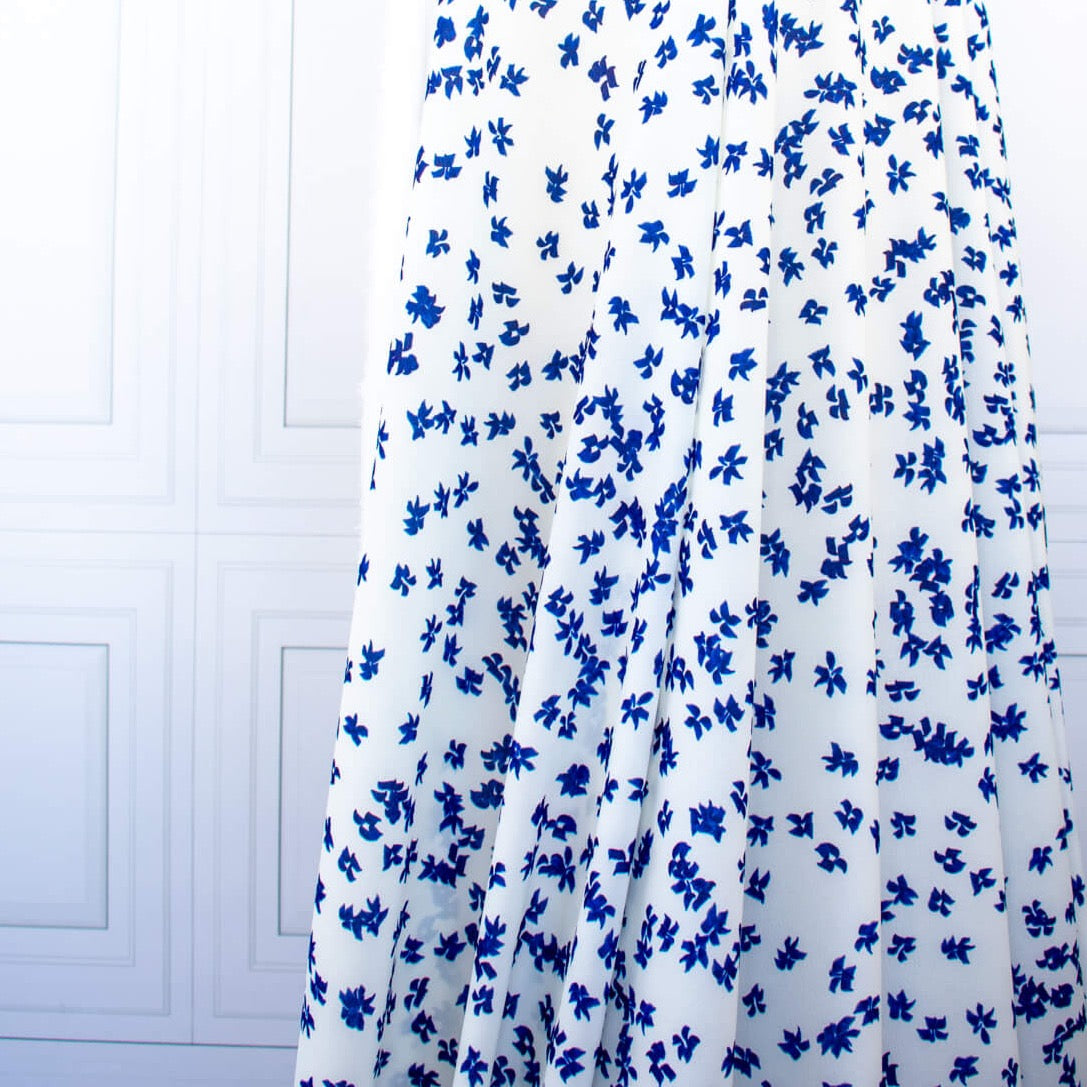 Image of fabric drape. Couture, Italian, blue and white floral crepe deadstock fabric by the yard. Sourced from a Los Angeles designer of ready-to-wear and bridal pieces and a favorite among some of Hollywoods A-List stars!
