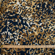Italian Animal Print Wool Blend Jersey knit fabric by the yard. Shades of gold and cream flow against dramatic coal a bits of blue to create a vibrant and sophisticated animal print design. This would make a lovely wrap style long cardigan, a bold fitted sheath dress, or pencil skirt. Image of fabric design and scale with ruler.