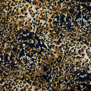 Italian Animal Print Wool Blend Jersey knit fabric by the yard. Shades of gold and cream flow against dramatic coal a bits of blue to create a vibrant and sophisticated animal print design. This would make a lovely wrap style long cardigan, a bold fitted sheath dress, or pencil skirt. Image of fabric design.
