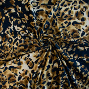 Italian Animal Print Wool Blend Jersey knit fabric by the yard. Shades of gold and cream flow against dramatic coal a bits of blue to create a vibrant and sophisticated animal print design. This would make a lovely wrap style long cardigan, a bold fitted sheath dress, or pencil skirt. Image of fabric fullness.