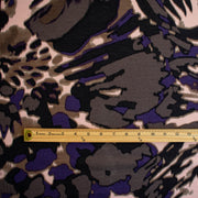 Italian Modern Floral Single Jersey Wool blend fabric by the yard. Gorgeous modern floral print perfect for transitioning to warmer months. This wool blend jersey in shades of brown, light pink, purple and black has a soft hand a beautiful drape. Whether you are creating a T-shirt or something a bit fancier, you're going to love how this fabric feels against your skin. Image of fabric design scale with ruler.