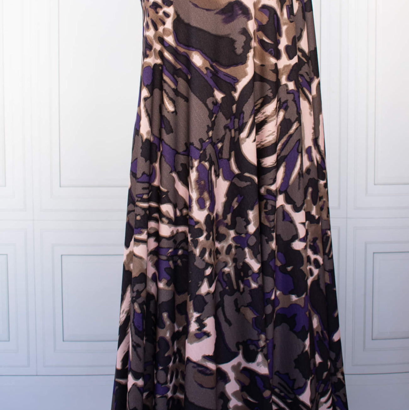 Italian Modern Floral Single Jersey Wool blend fabric by the yard. Gorgeous modern floral print perfect for transitioning to warmer months. This wool blend jersey in shades of brown, light pink, purple and black has a soft hand a beautiful drape. Whether you are creating a T-shirt or something a bit fancier, you're going to love how this fabric feels against your skin. Image of fabric drape.