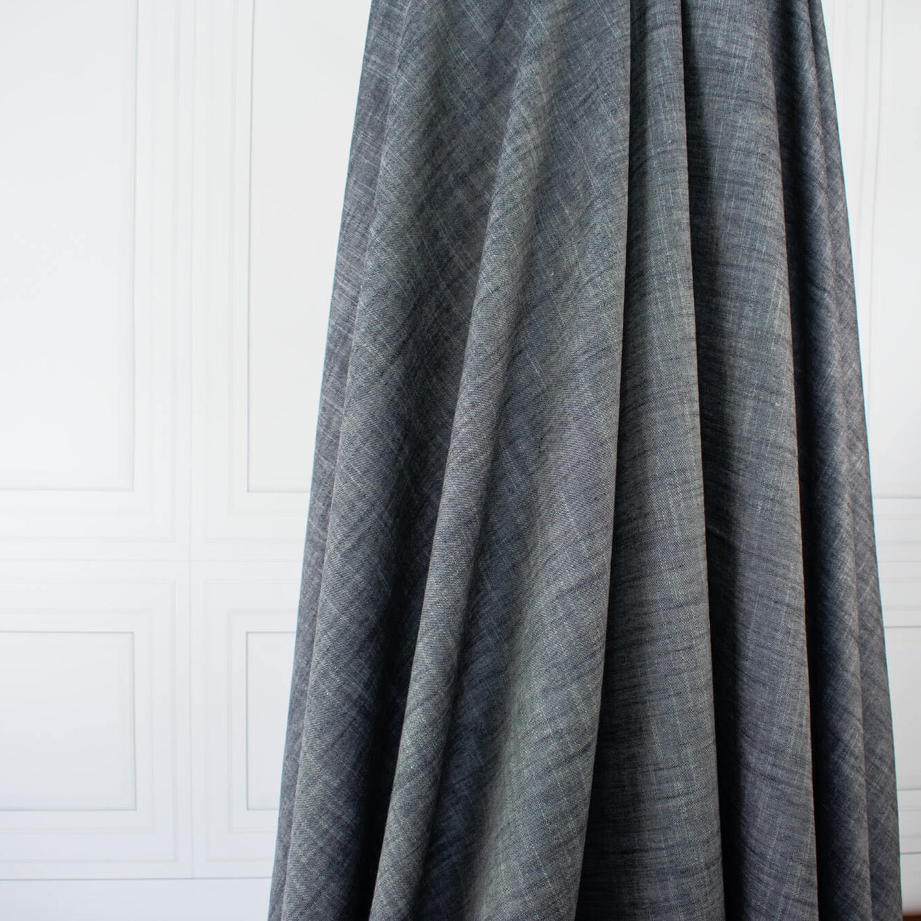 Stay cool and look amazing while you enjoy the breathability and sustainability of Tencel and all you love about linen in one gorgeous dark indigo fabric.   On the lighter side of a mid-weight with a beautiful sheen, nice drape, and softly textured hand you'll look 'Tres Chic'!  Image of fabric drape.