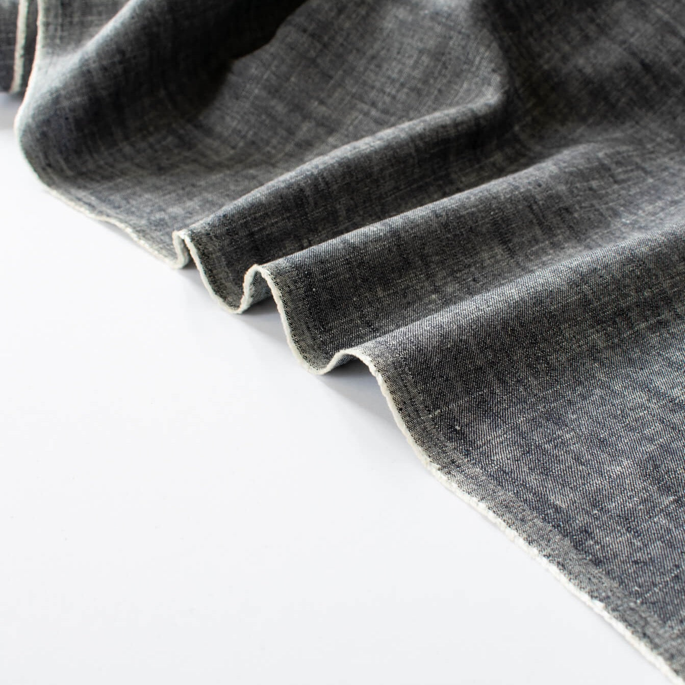 Stay cool and look amazing while you enjoy the breathability and sustainability of Tencel and all you love about linen in one gorgeous dark indigo fabric.   On the lighter side of a mid-weight with a beautiful sheen, nice drape, and softly textured hand you'll look 'Tres Chic'!  Image of selvedge edge.