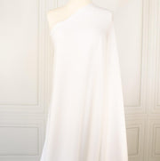 High-End Designer Pearl White Ponte Knit fabric by the yard. This Los Angeles designer has a knack for finding quality fabrics. This designer deadstock Ponte is soft with a nice drape that falls moderately close to the body. You'll fall in love with the comfort! Image of fabric on dress form.