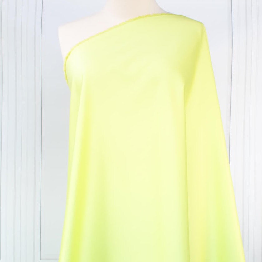 Have some fun in this delightful soft lime green cotton sateen fabric by the yard. Perfect when you want to add a bit of pizzazz to your outfit. The soft lightly brushed hand with the slightest sheen would sew up a lovely shirtdress,  jacket or ankle length pant! Image of fabric on dressform.