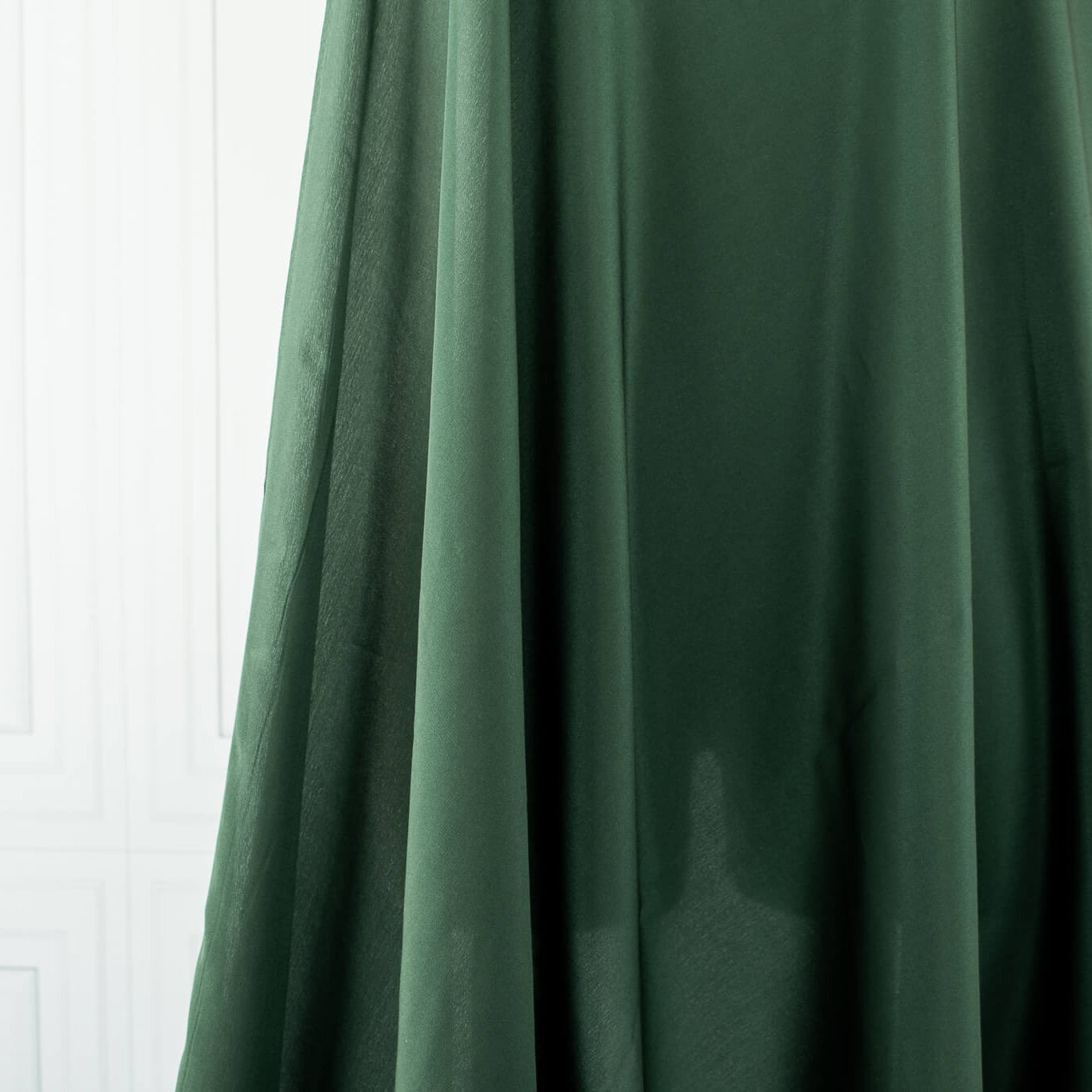 100% Silk Crepe de Chine fabric by the yard in Fern Green. Soft and fluid, this semi-textured fabric offers a beautiful drape and the luxury of silk. Image of fabric drape.