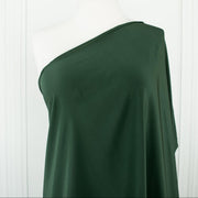 100% Silk Crepe de Chine fabric by the yard in Fern Green. Soft and fluid, this semi-textured fabric offers a beautiful drape and the luxury of silk. Image of fabric  drape on dressform.