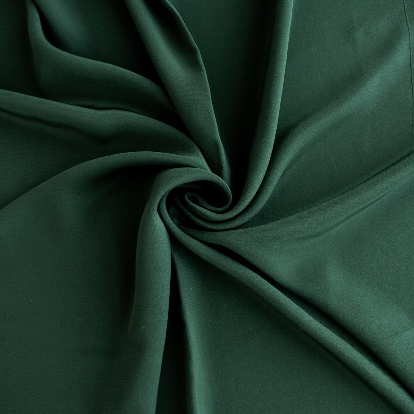100% Silk Crepe de Chine fabric by the yard in Fern Green. Soft and fluid, this semi-textured fabric offers a beautiful drape and the luxury of silk. Image of fabric fullness.