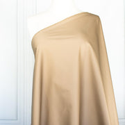 Looking to create a more 'Mindful' wardrobe? You'll love our Cotton Stretch Sateen - a designer deadstock fabric by the yard with a touch of spandex for the perfect amount of stretch. Image of fabric draped on dress form.