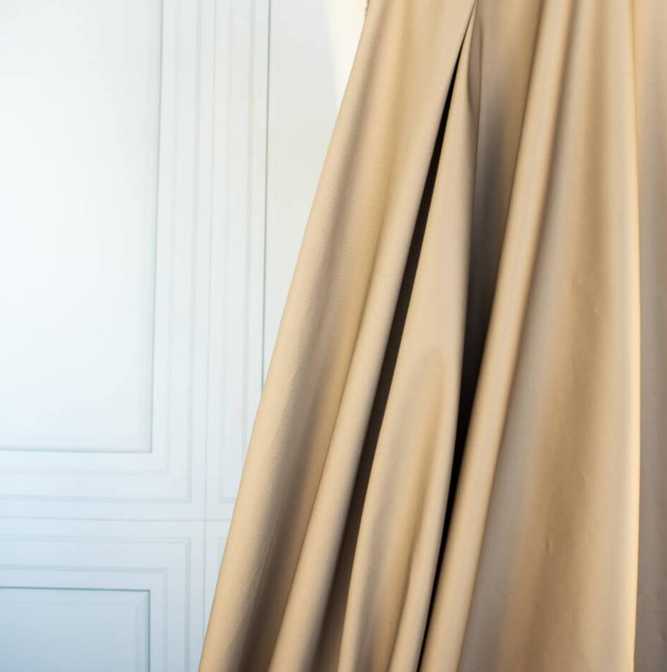 Looking to create a more 'Mindful' wardrobe? You'll love our Cotton Stretch Sateen - a designer deadstock fabric by the yard with a touch of spandex for the perfect amount of stretch. Image of fabric drape.
