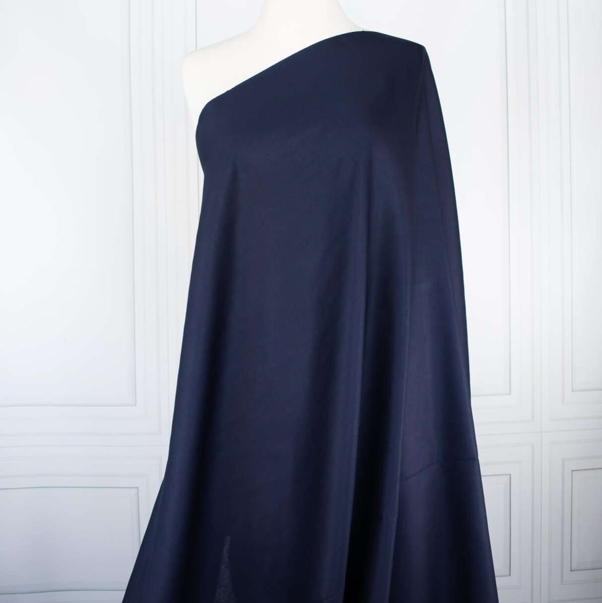 Fine Egyptian Pima Cotton Pique Shirting fabric by the yard. Imported from Switzerland, our fabric boasts a luxurious cotton that is semi-sheer and has a soft, semi-crisp hand. Perfect for a high-end and comfortable shirt, dress, skirt or top! Image of fabric draped on dressform.