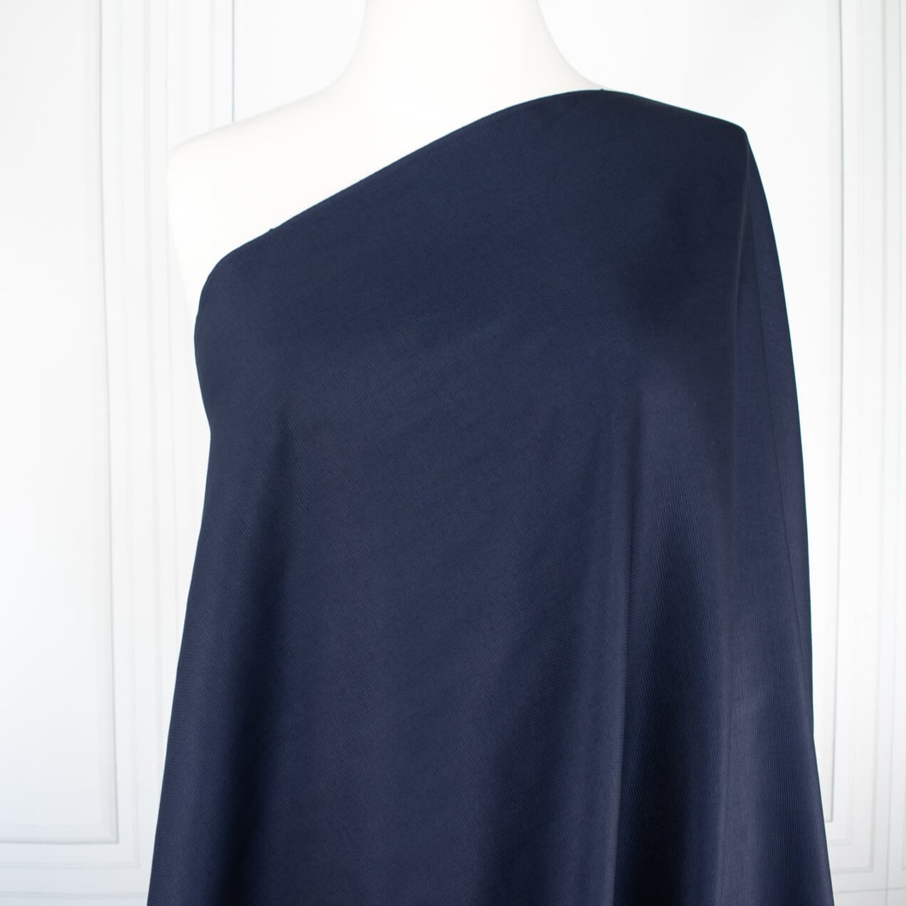 Fine Egyptian Pima Cotton Pique Shirting fabric by the yard. Imported from Switzerland, our fabric boasts a luxurious cotton that is semi-sheer and has a soft, semi-crisp hand. Perfect for a high-end and comfortable shirt, dress, skirt or top!  Image of fabric on dressform.