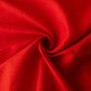 Red mid-weight linen fabric by the yard is just plain gorgeous. The fabric has a soft hand, slight slubbing, and the mid-weight makes it a perfect choice for tailored garments such as jackets and fitted sheath dresses or suitings.Close up image of fabric fullness.