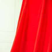 Red mid-weight linen fabric by the yard is just plain gorgeous. The fabric has a soft hand, slight slubbing, and the mid-weight makes it a perfect choice for tailored garments such as jackets and fitted sheath dresses or suitings.Close up image of fabric drape.