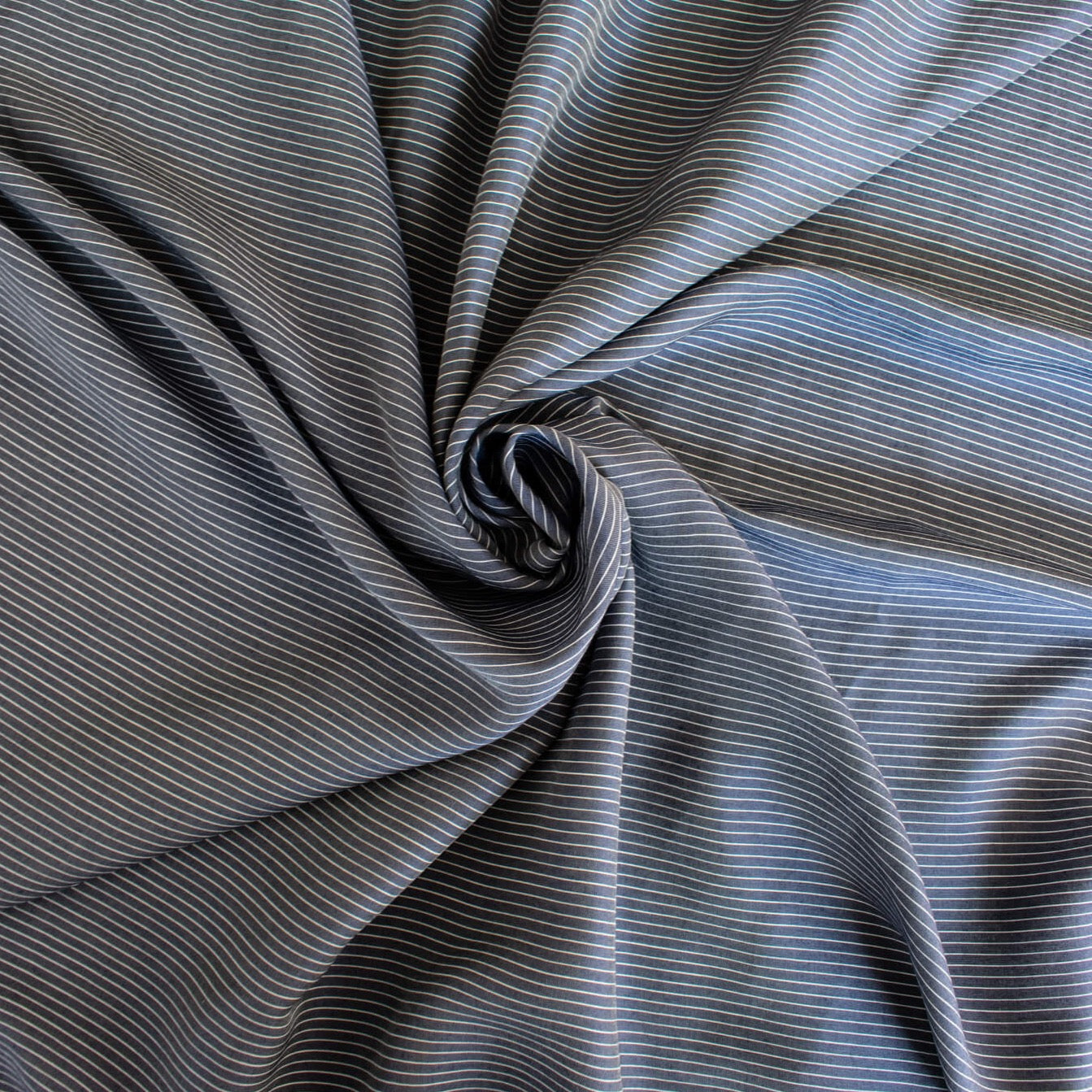 NYC Designer Deadstock Cotton Voile fabric by the yard. Amazingly soft and silky, this Navy/White horizontal stripe voile is lightweight with a thin hand, a must for warmer temperatures. Image of fabric fullness.